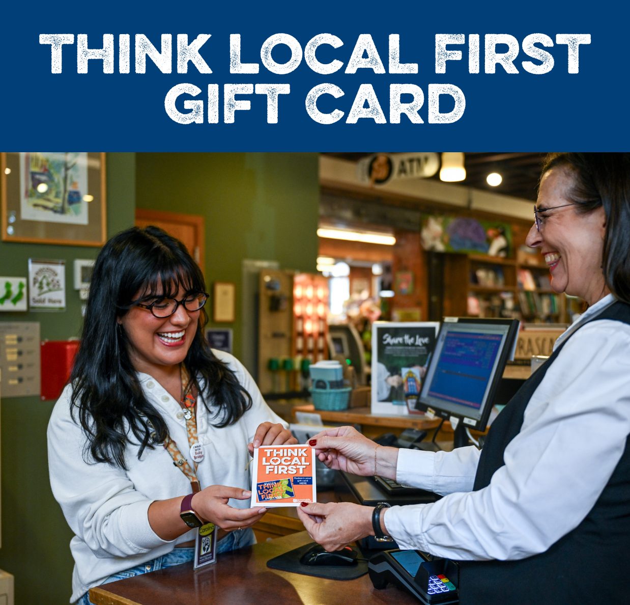Gift Card_Square Image Block One person hands another person a paper saying think local first gift card and smiles