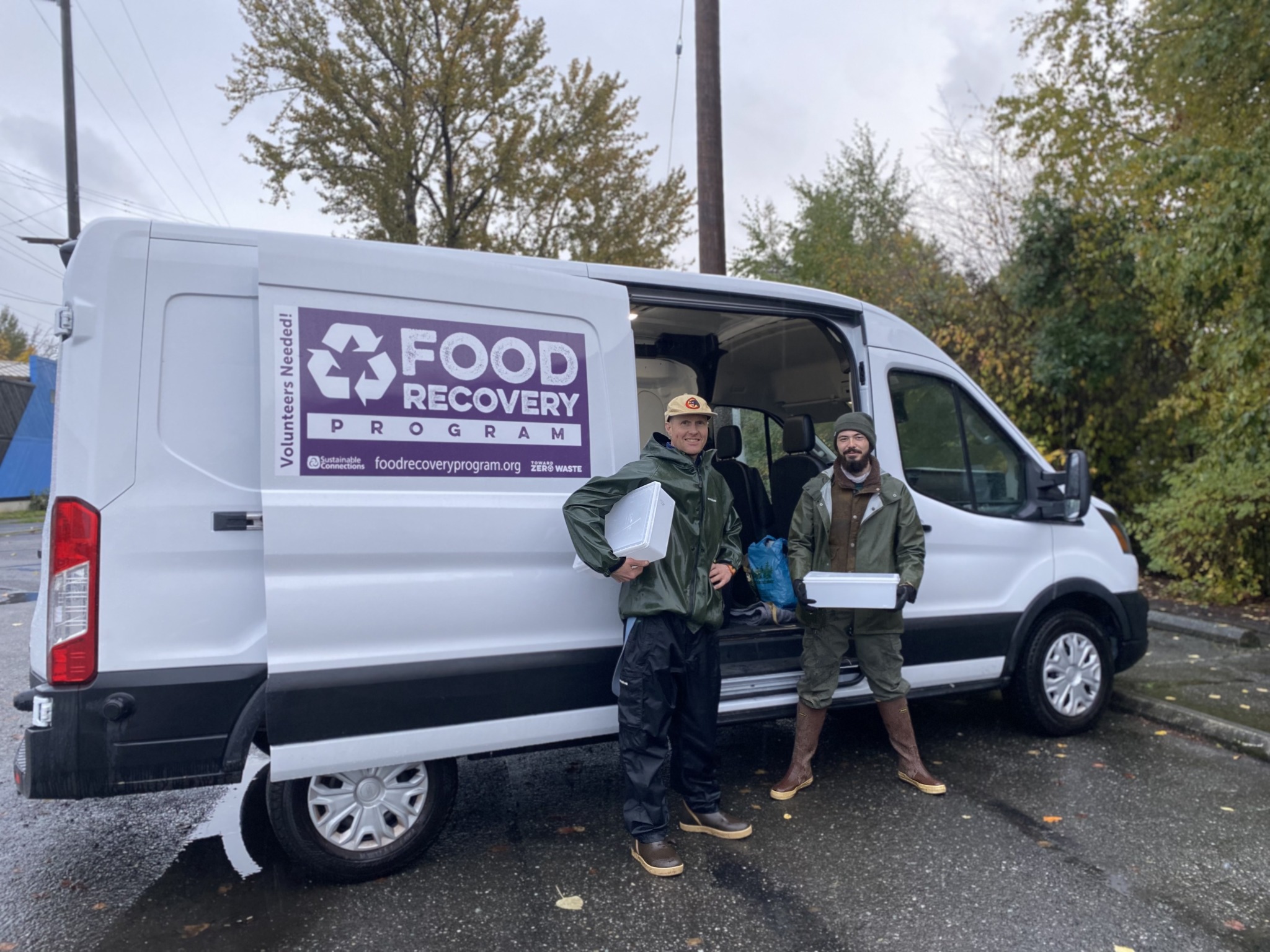 Hunter and Cedar with Van 3 two people with food recovery tubs standing in front of the food recovery van