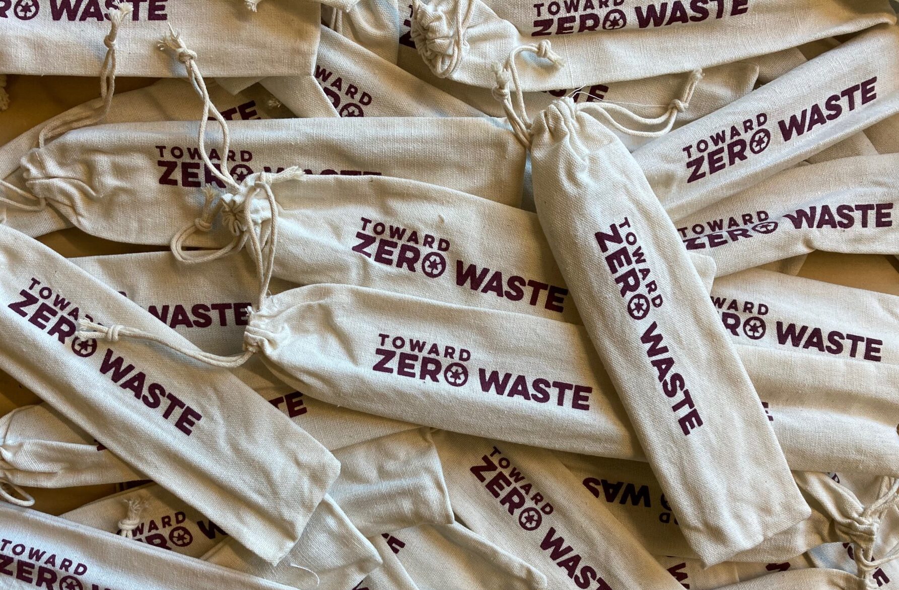 Burlap bags with Toward Zero Waste logo on them