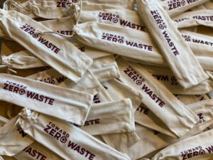 Burlap bags with Toward Zero Waste logo on them