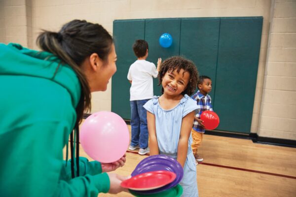 Child smiling at adult while playing