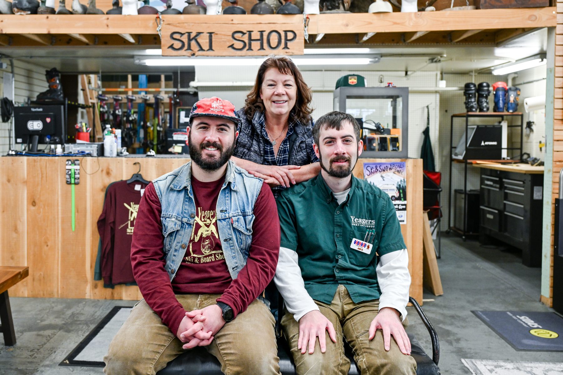 Owner family of Yeagers sporting goods pose in front of ski shop 