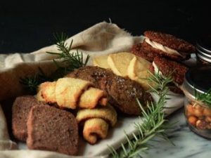 A festive tray of an assortment of holiday cookies and baked goods.