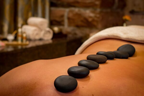 Hot stones on a massage patient's back