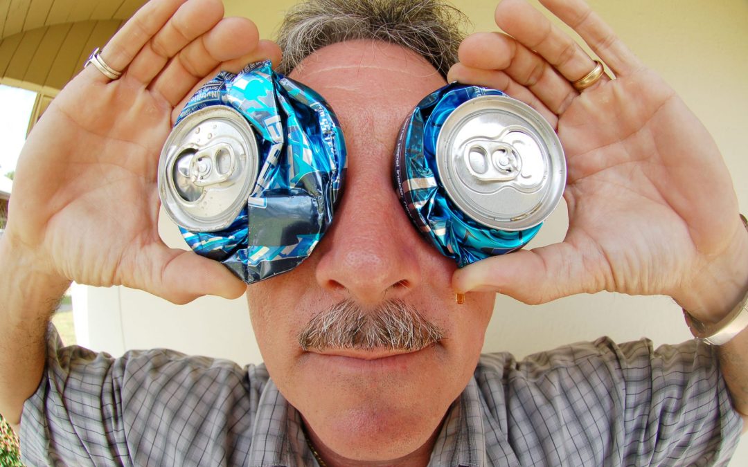 man with recycled can glasses