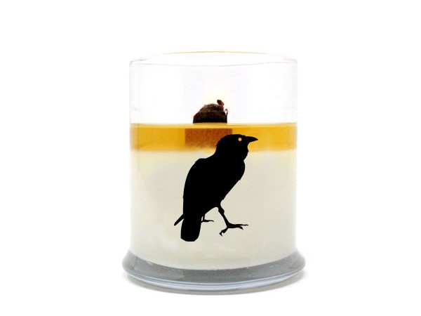 A pure soy wax candle from Sea Witch Botanicals with the silhouette of a raven on the side. 